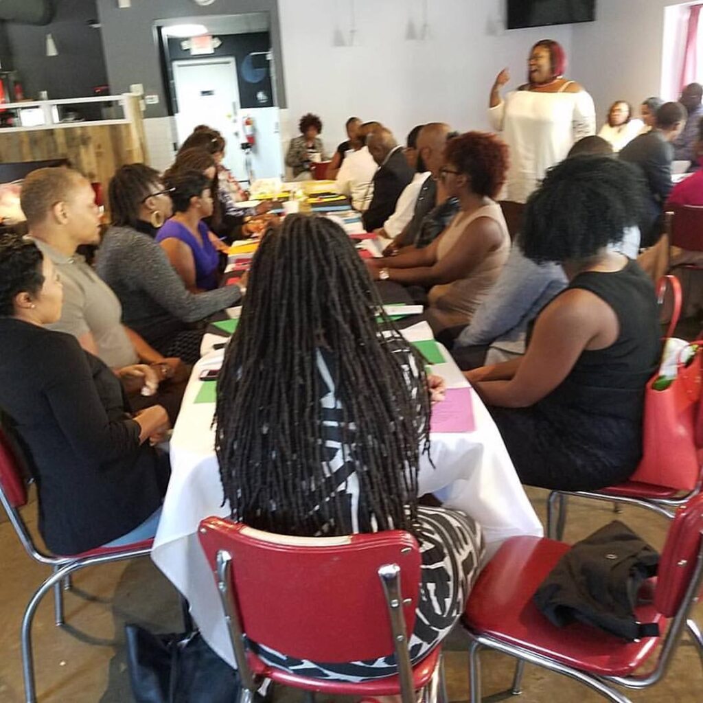 room of adults sitting at tables